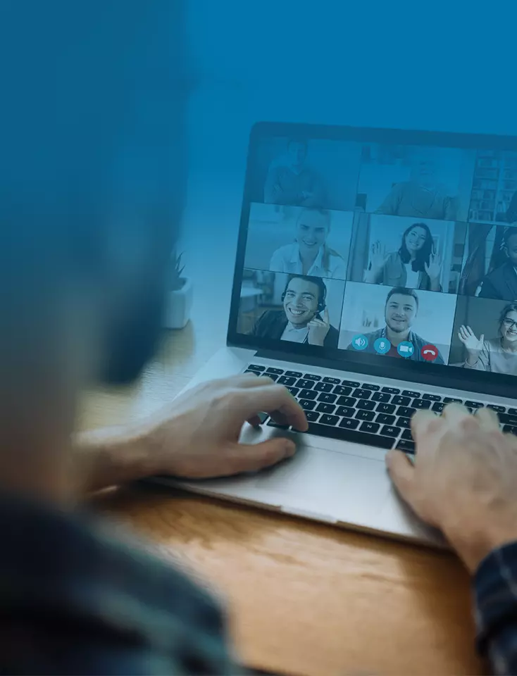 One person uses a laptop for a video conference.