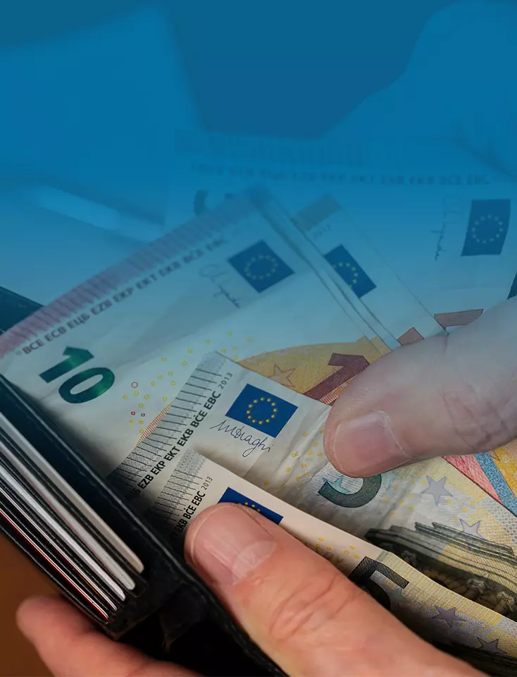 A person holds a wallet with euro banknotes.